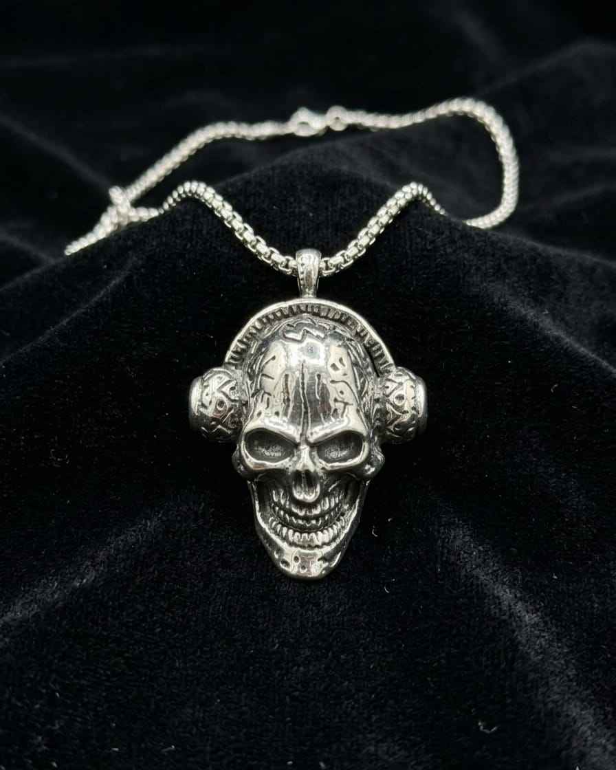 Silver-toned skull pendant necklace with twisted chain, detailed skull face