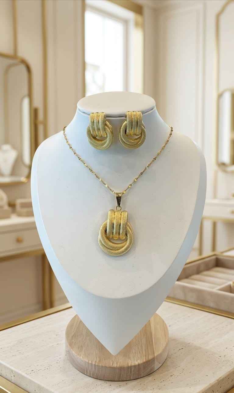 Gold-tone sculpted knot necklace set with pendant and stud earrings