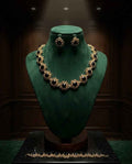 Gold blossom necklace set with dark gemstone collar and matching drop earrings