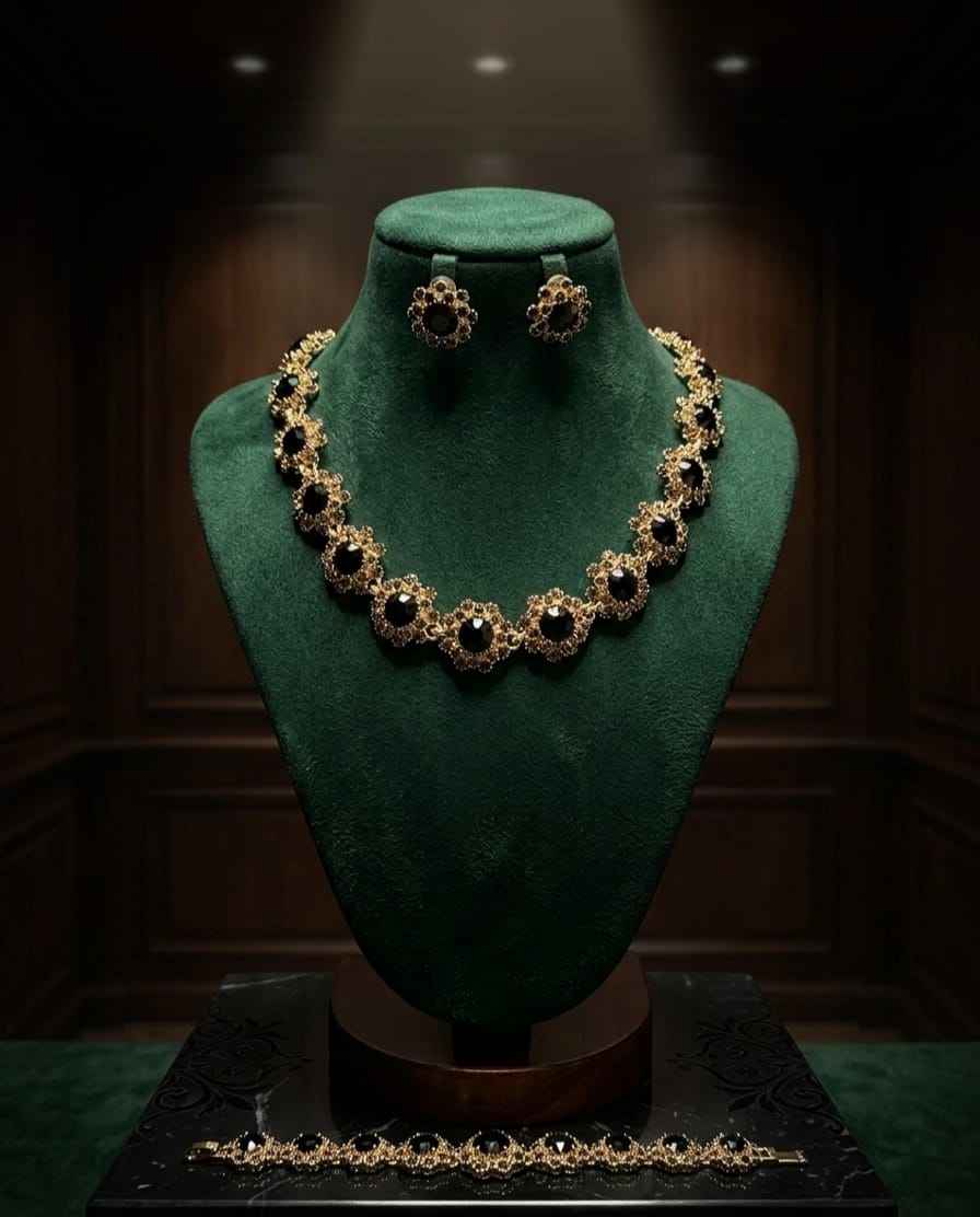 Gold blossom necklace set with dark gemstone collar and matching drop earrings