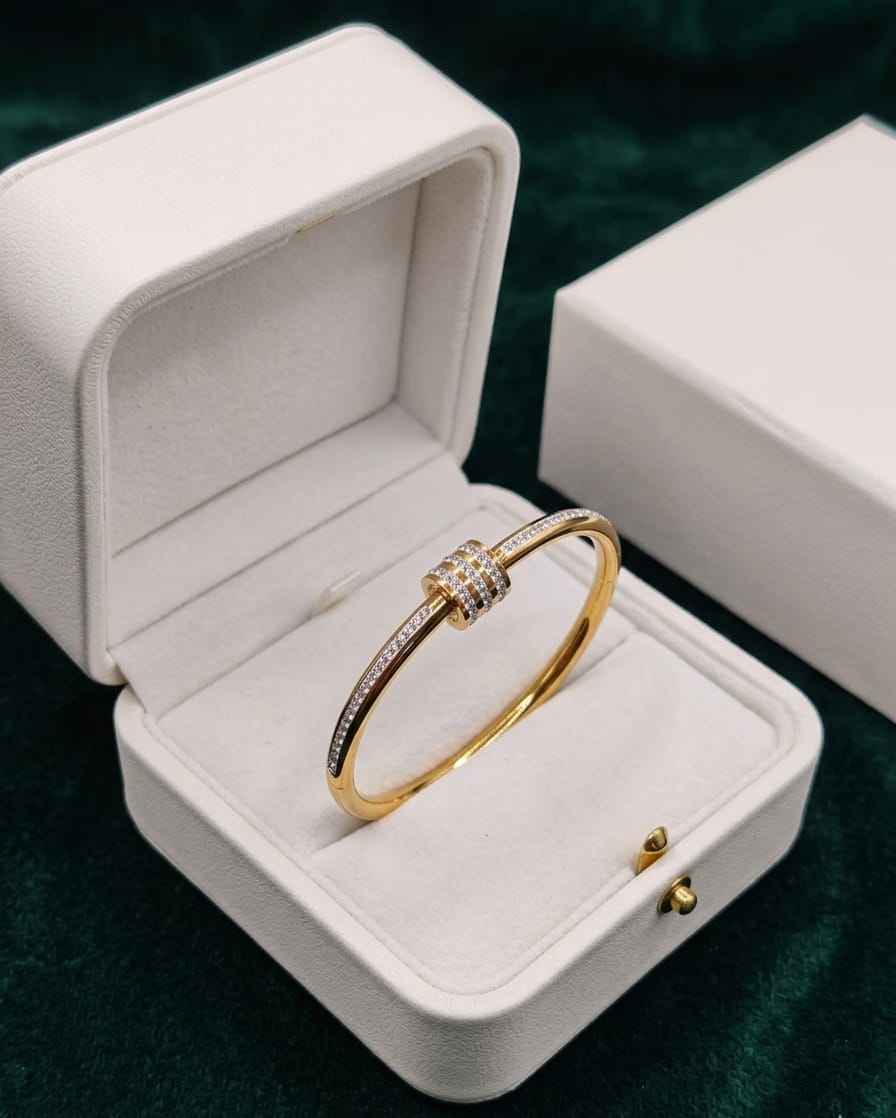 Gold open bangle with pavé crystal accents and hinged clasp
