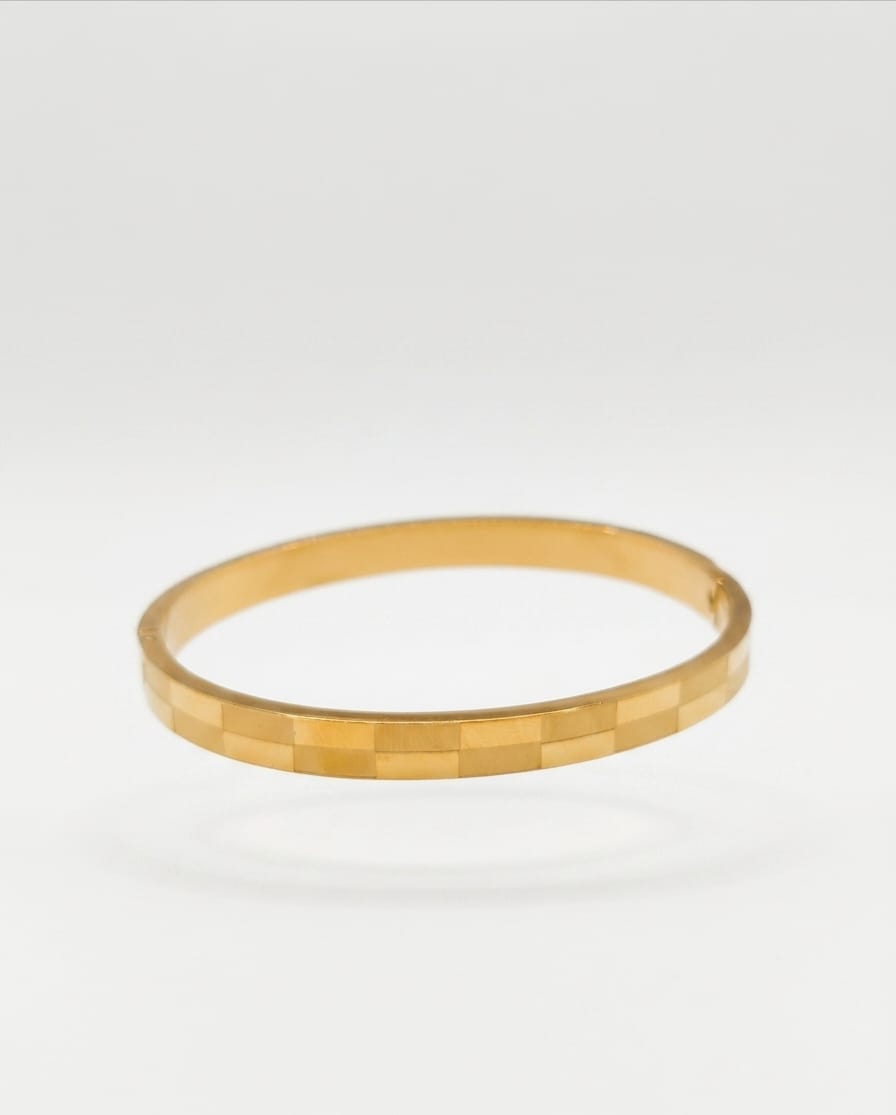 Gold faceted bangle bracelet with square pattern band