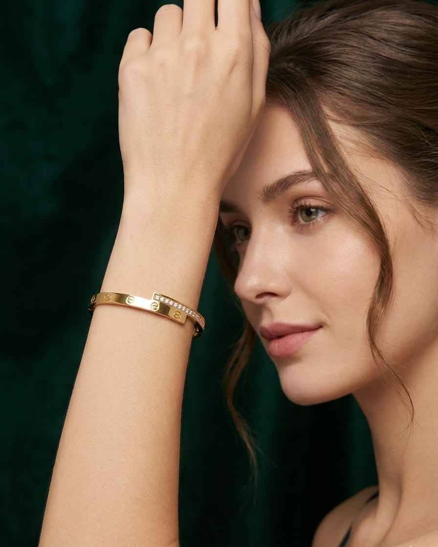 Gold screw-motif bangle with pavé stones, worn on a wrist
