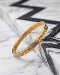 Gold-tone clover pavé bangle with small gemstone insets along the band