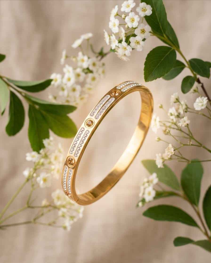 Gold-tone pavé link bangle with engraved-style rows and round stone accents