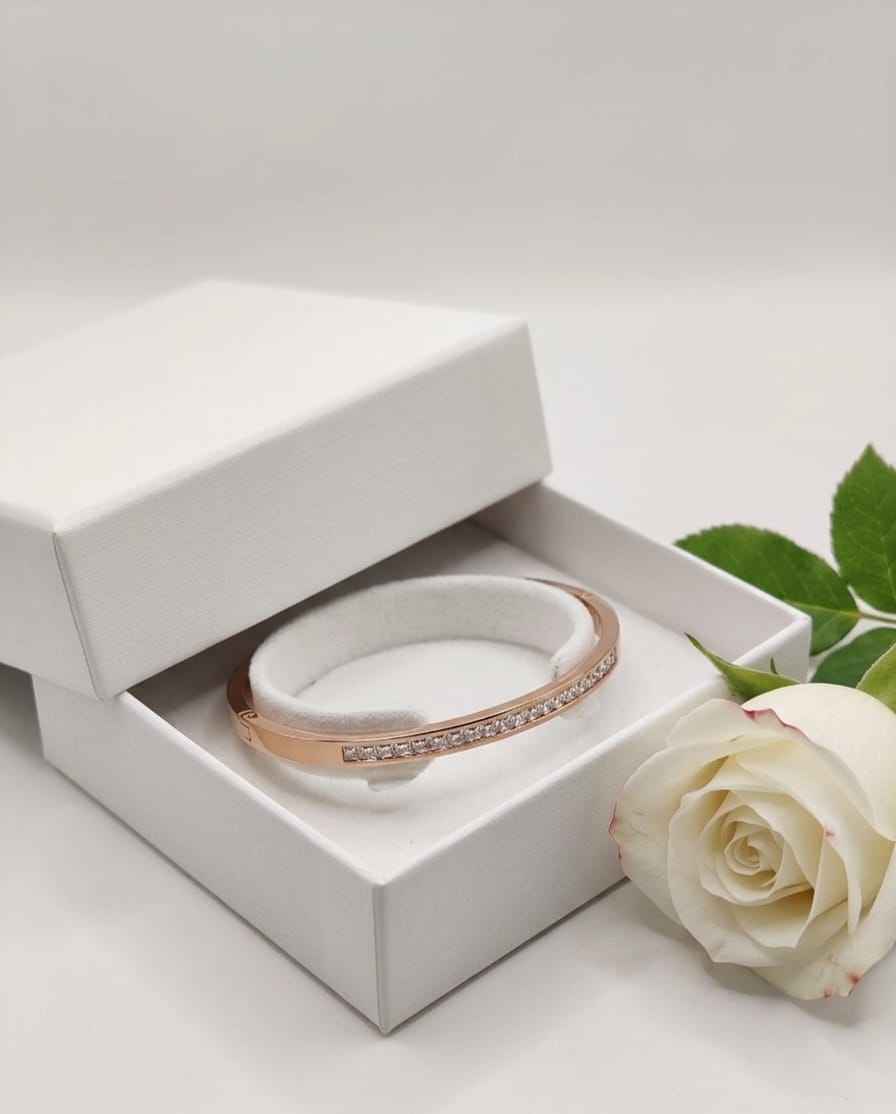 Rose gold pavé bangle in a jewelry box, single row of clear stones