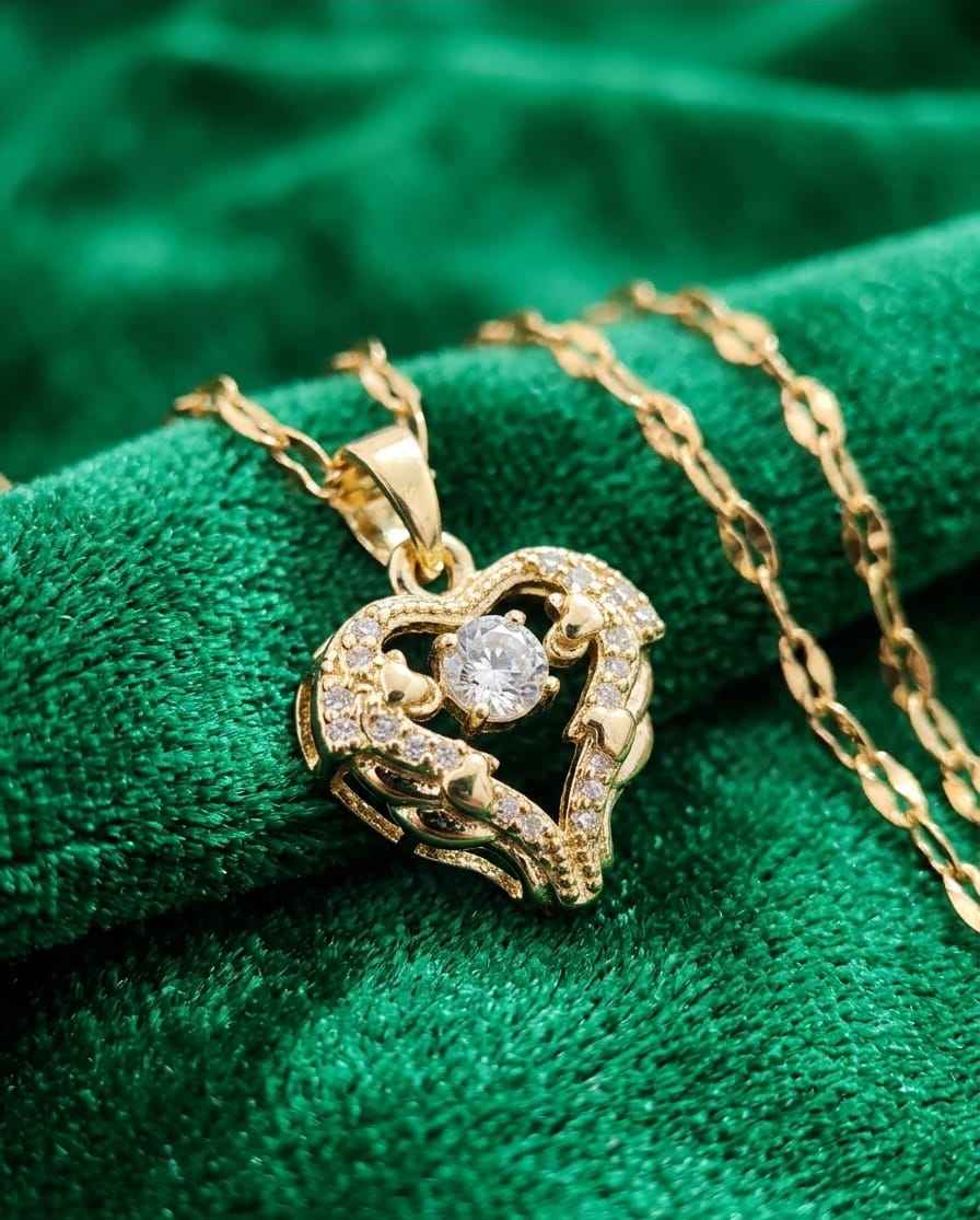 Gold-tone heart pendant necklace with round gemstone and sparkling pave detail