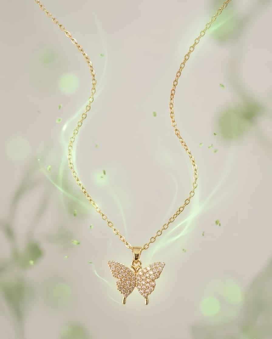 Gold butterfly pendant necklace with pavé details on a thin chain