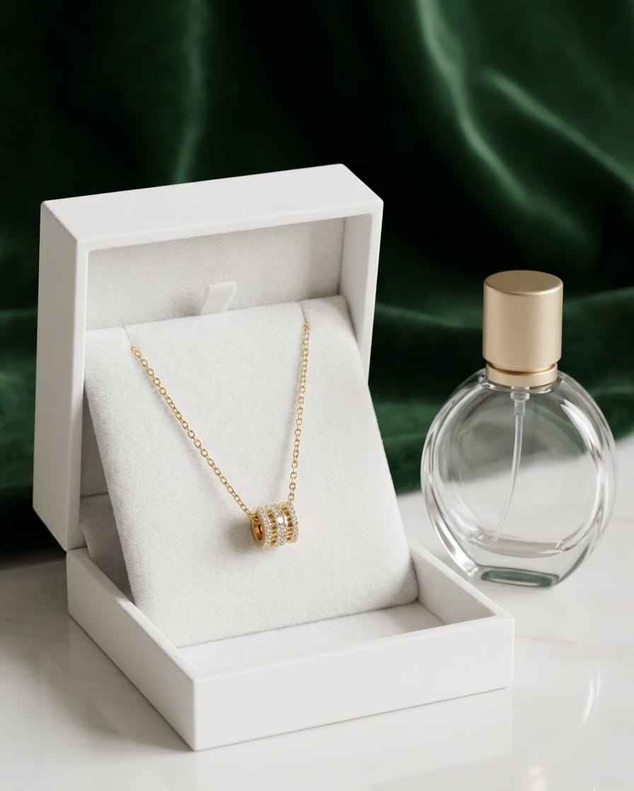Gold pavé bar necklace on white jewelry box, rectangular sparkling pendant