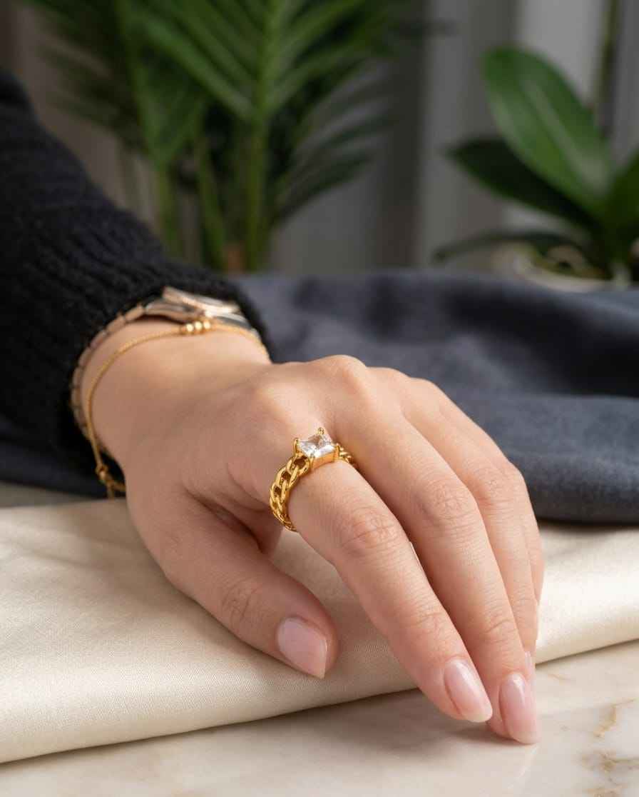 Gold-tone chain solitaire ring on hand with square clear center stone