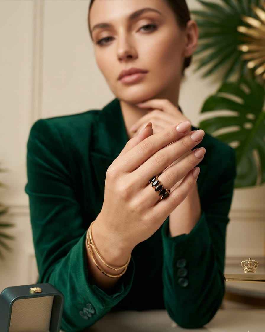 Open marquise gemstone ring with dark stones and gold-tone prong setting