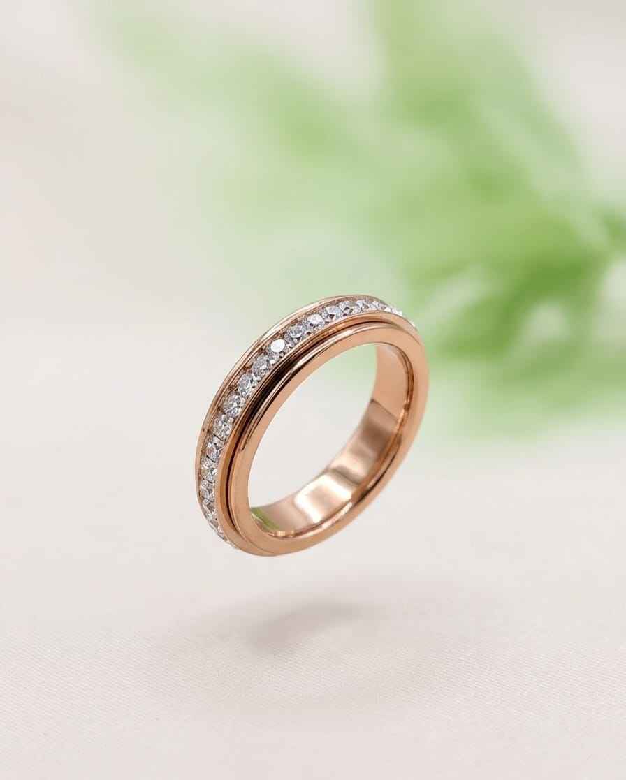 Rose gold pavé band ring with clear stones set around the ring front
