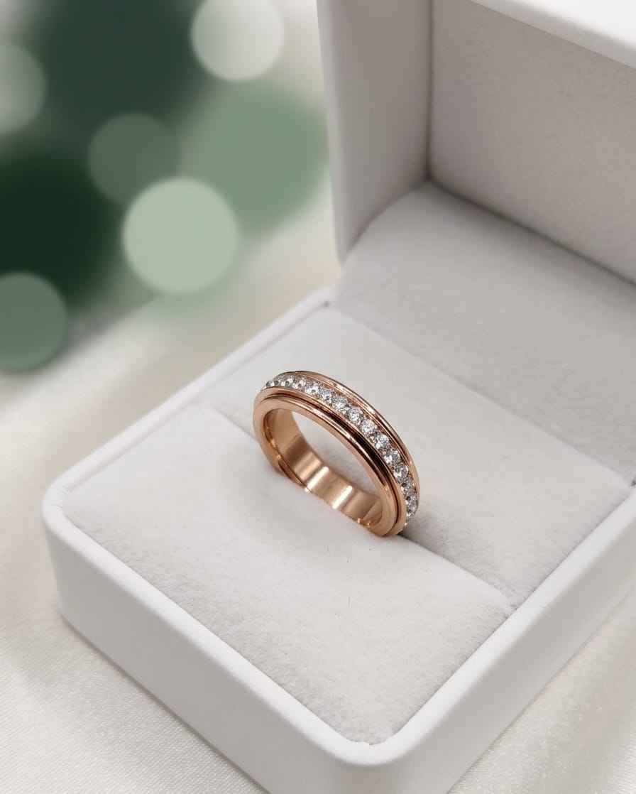 Rose gold pavé band ring with clear stones, shown in a white jewelry box