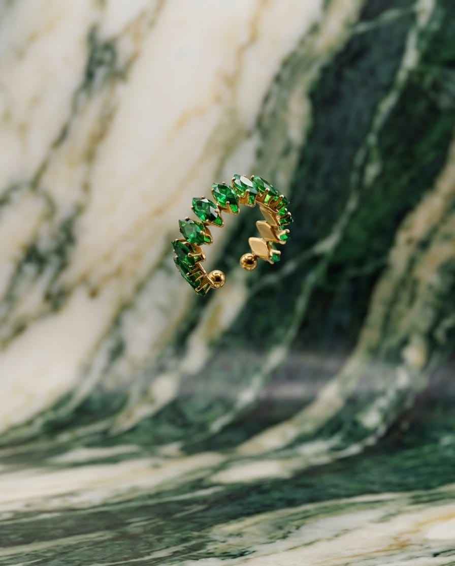 Open crown ring with emerald-green gemstone stones and gold-tone band