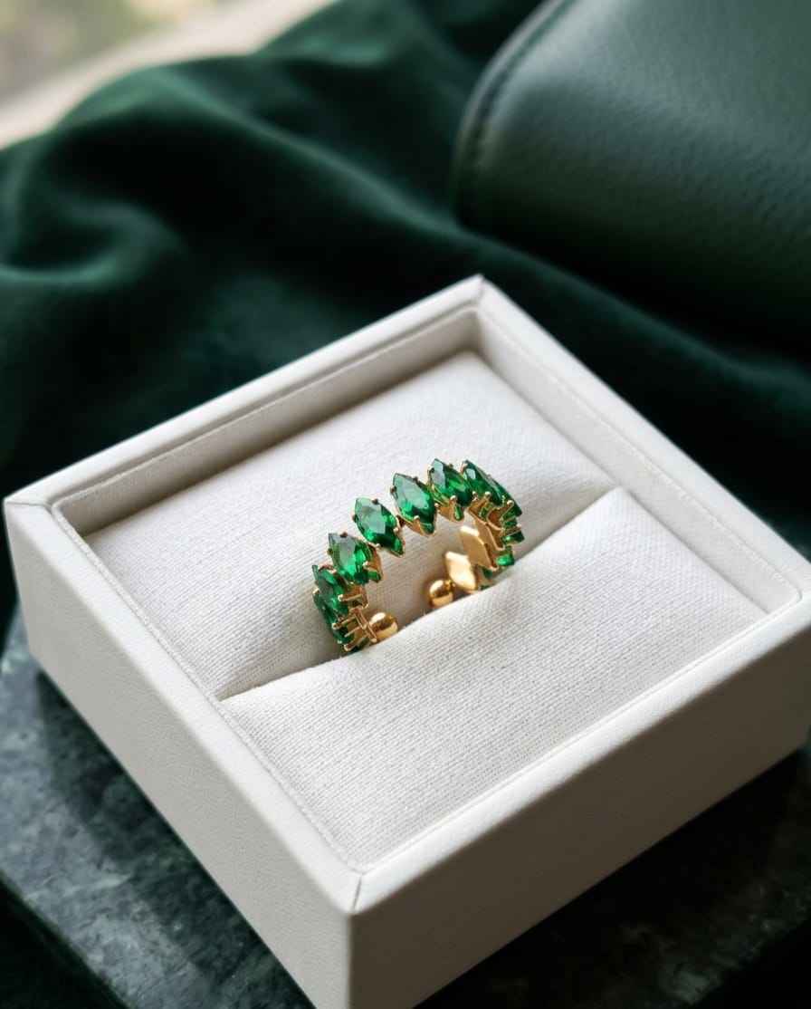 Gold open crown ring with emerald-green stones, shown in a gift box