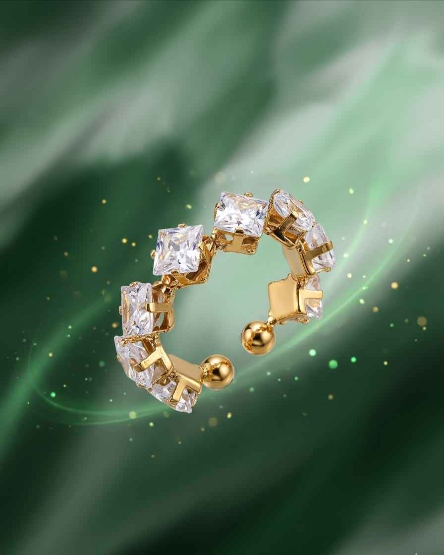 Gold-tone crystal ring featuring square stones set in an open circular design