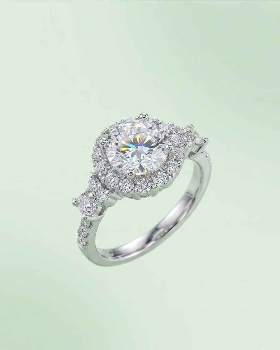 Oval halo engagement ring with large center stone and pavé side stones
