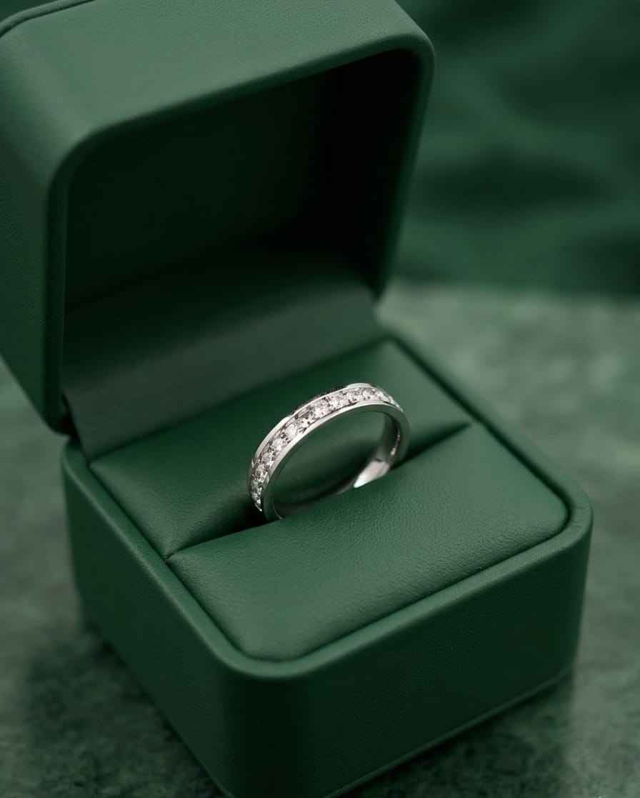 Silver eternity band ring with small clear stones in green gift box