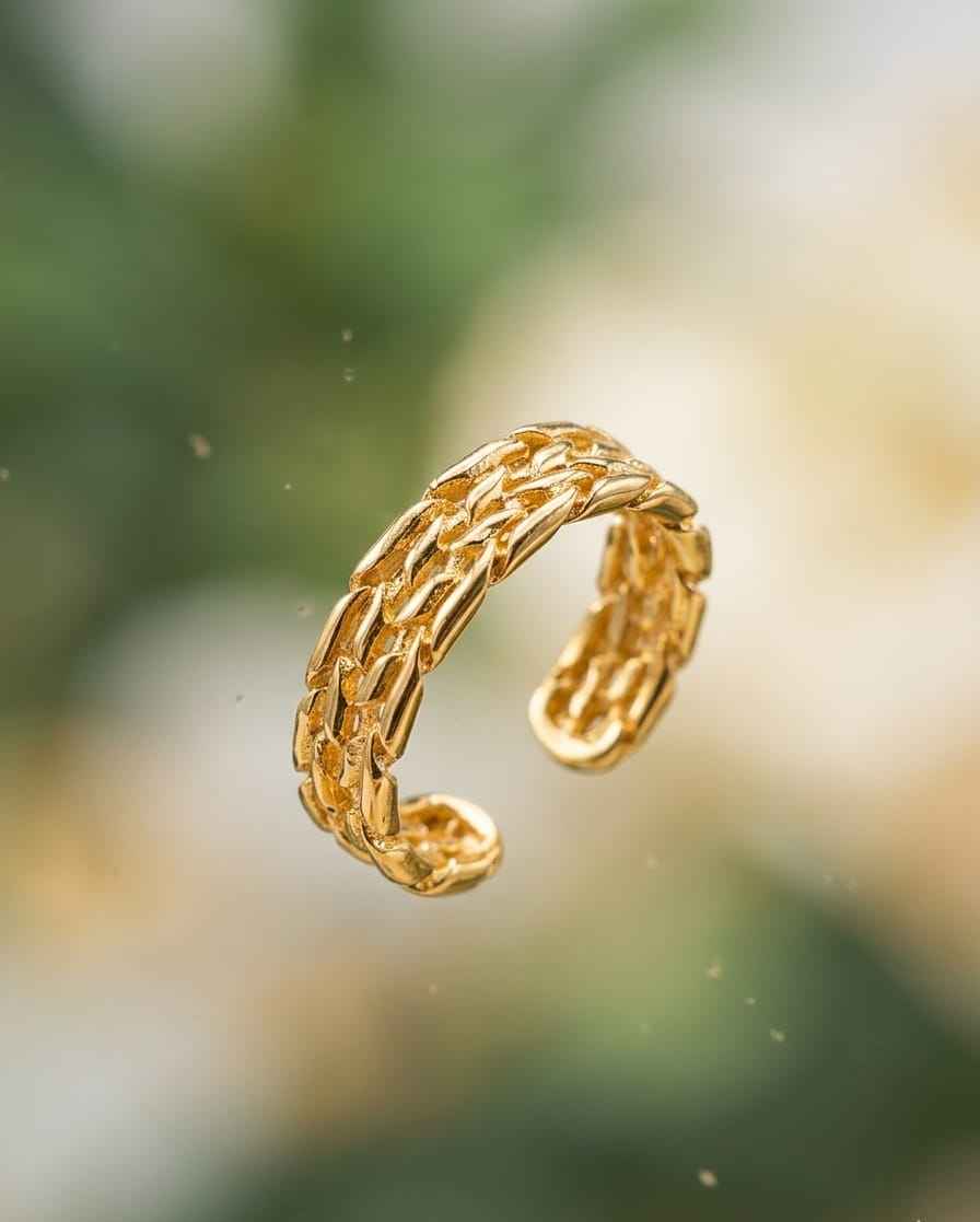 Roceen golden chain-weave ring in gold tone, textured woven links.