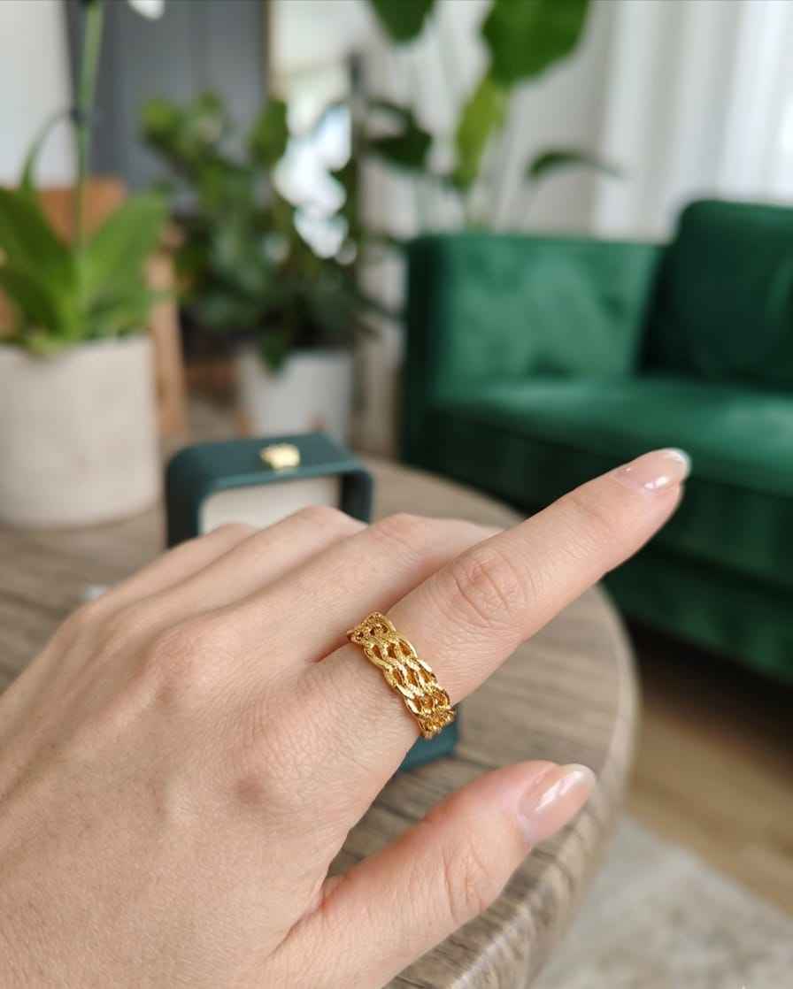 Roceen golden chain-weave ring with interlinked braid pattern.