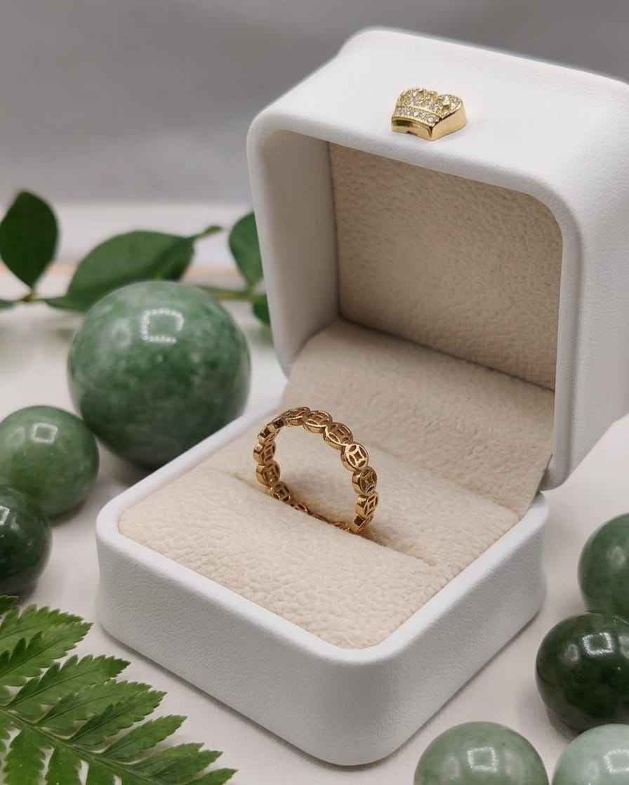 Gold chain-weave ring in a white jewelry box