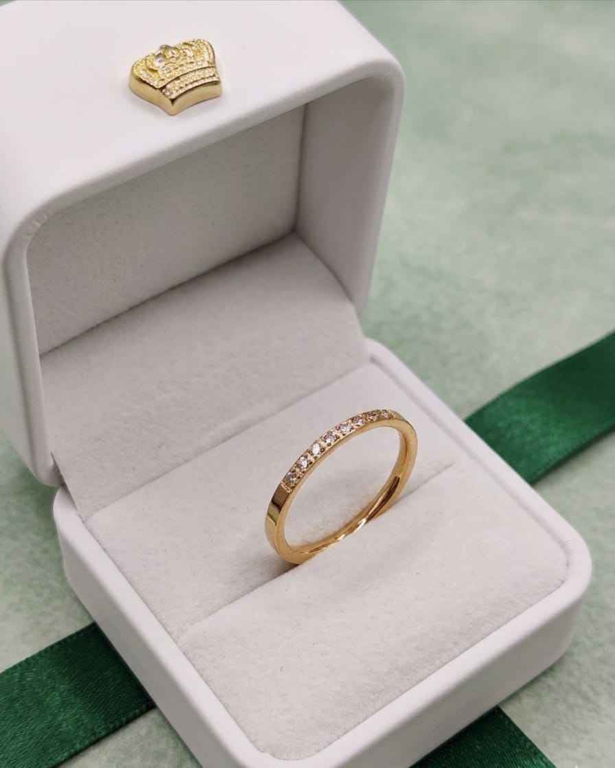 Gold pavé dainty ring with small clear stones in a white ring box