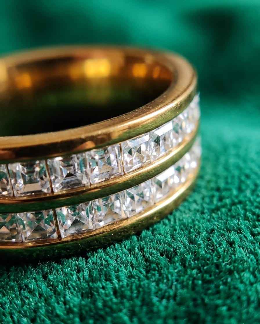 Gold-tone double-row crystal ring close-up with diamond-like stones