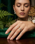 Gold double-row crystal ring on finger