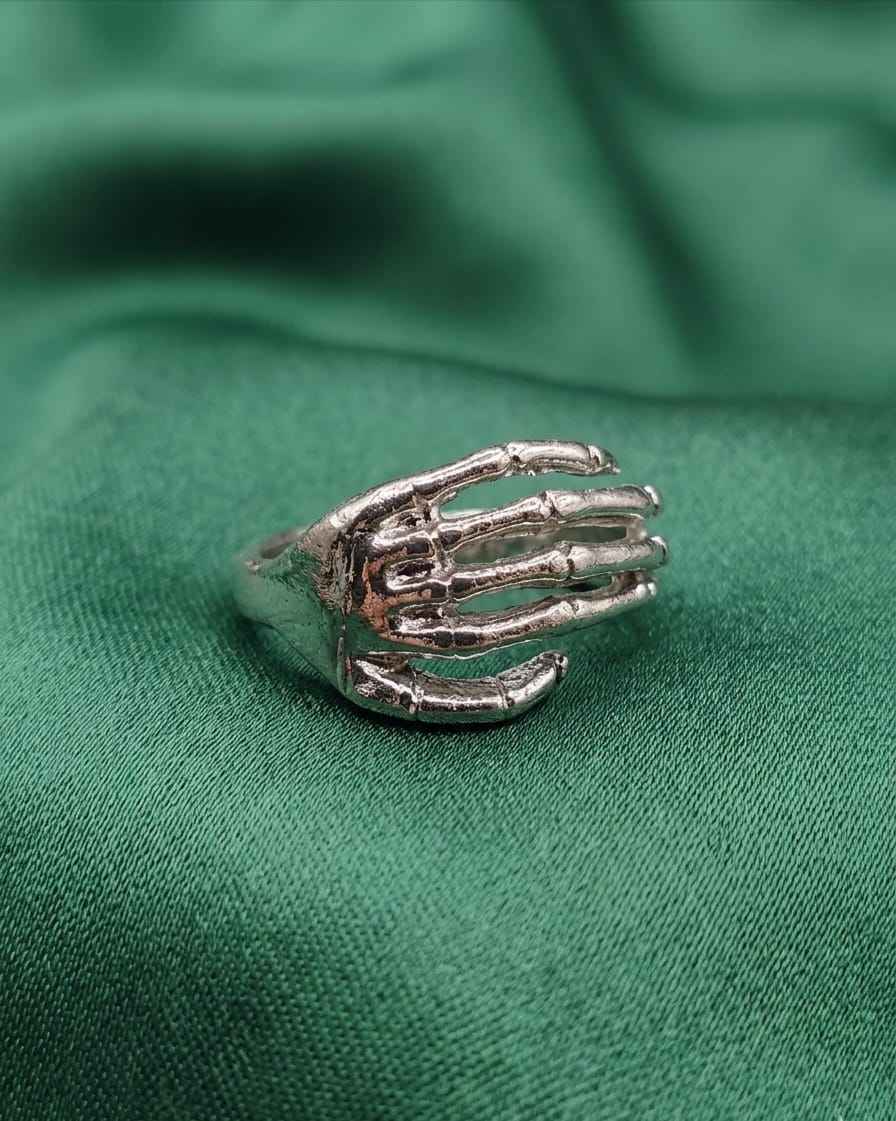 925 silver sculpted hand ring on green fabric, arched claw motif with green stones
