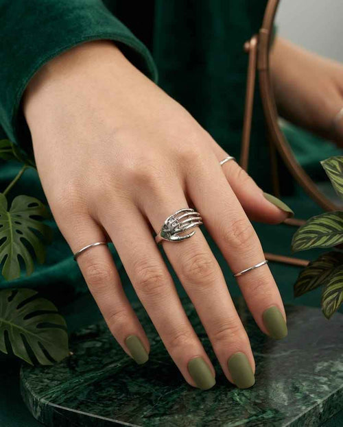 925 silver sculpted hand ring on finger, stacked claw-style design, reflective finish