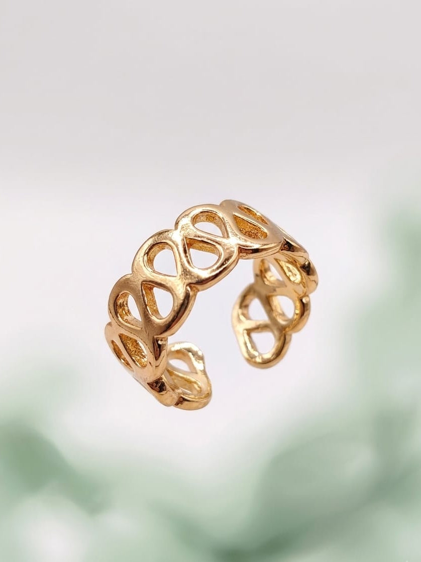 Open loop ring angled view, gold-tone open lattice band with oval cutouts.