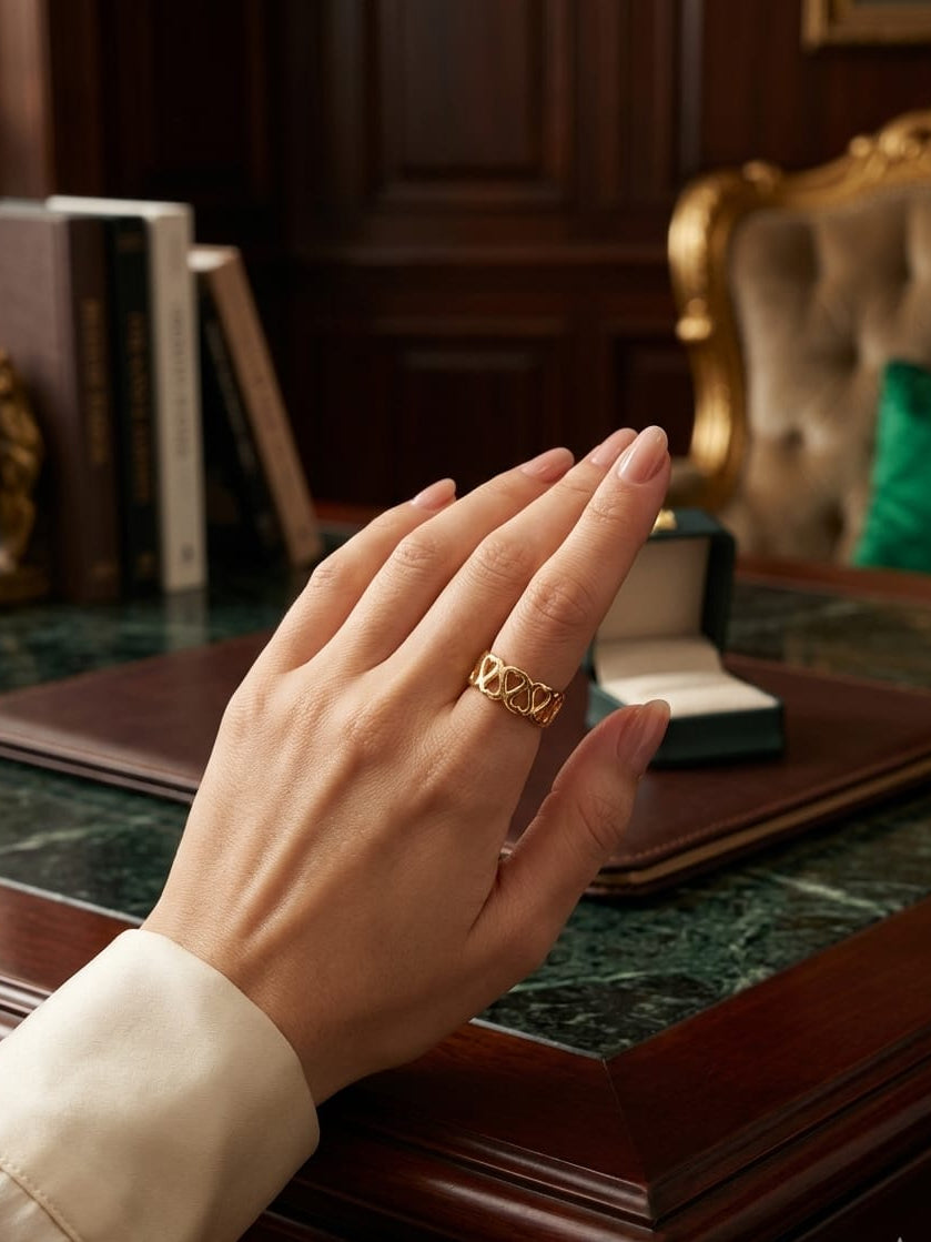 Open loop ring on hand, gold-tone open lattice band with rounded links.