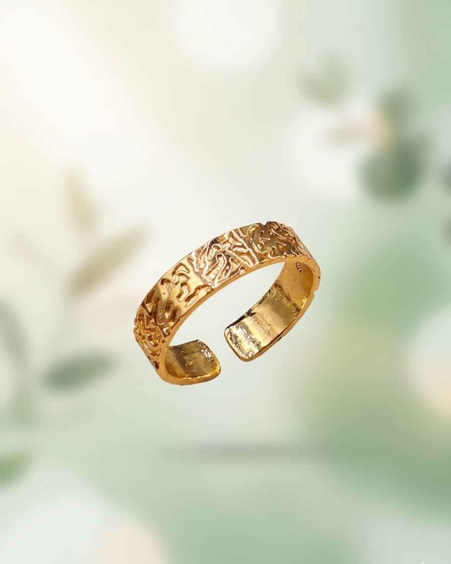 Gold-tone engraved band ring, top view showing interior and pattern