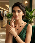 Gold-tone clover jewelry set on model: clover necklace and matching drop earrings