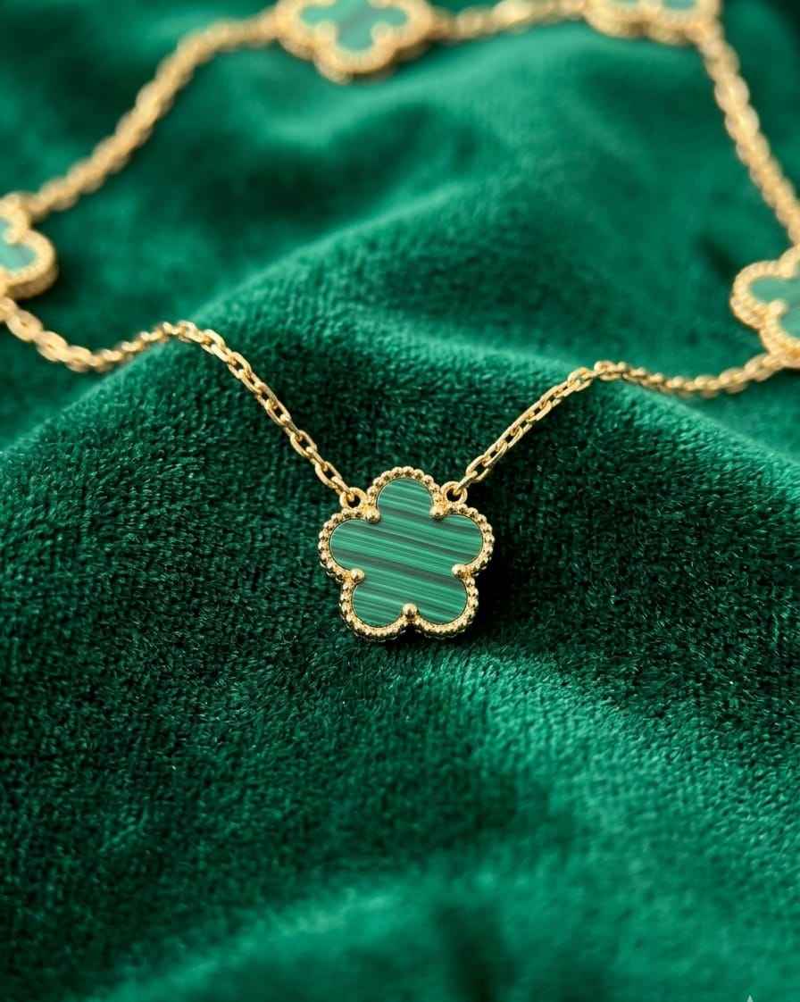 Gold clover pendant necklace with green enamel charm and chain