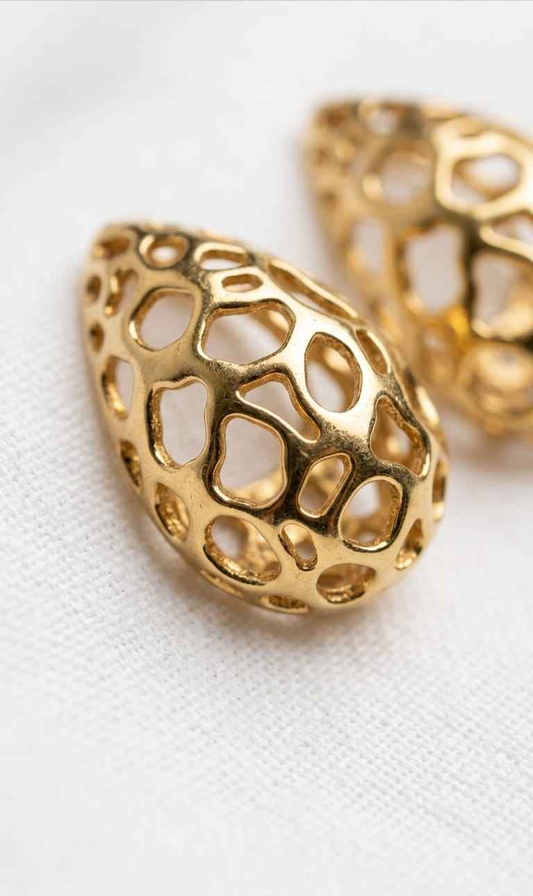 Gold filigree teardrop stud earring with intricate openwork detail