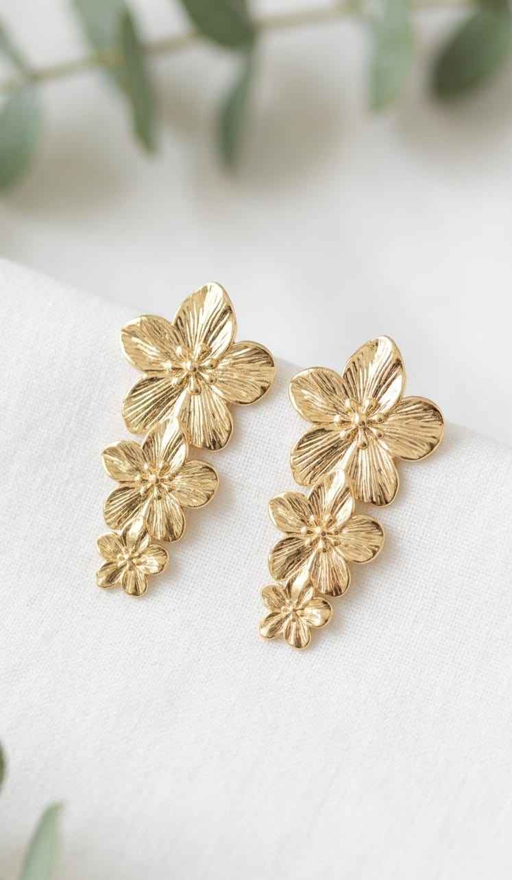 Gold floral drop earrings with four layered flower charms on each earring