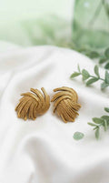 Gold swirl textured stud earrings with curled fan ridges