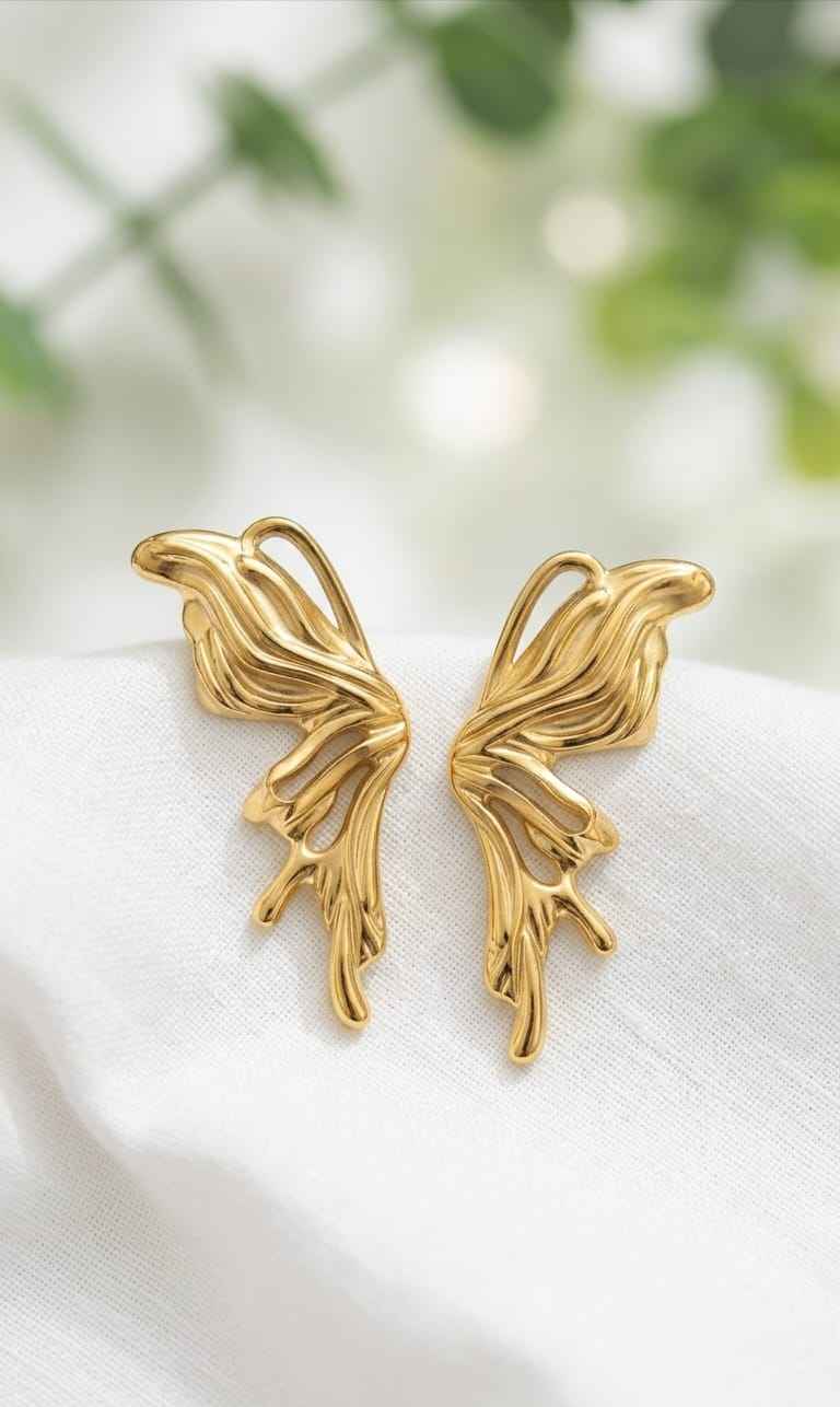 Gold sculptural drop earrings with curved leaf-like shapes