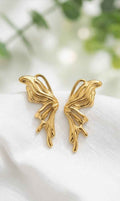 Gold sculptural drop earrings with curved leaf-like shapes