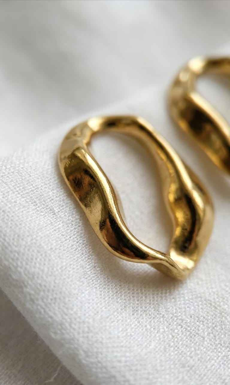 Gold open-shape hoop stud earrings, curved oval with textured finish