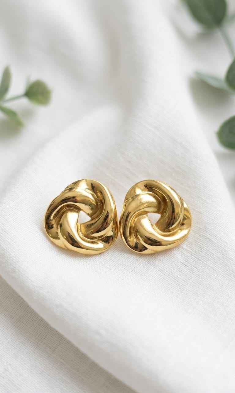 Gold twisted knot stud earrings with glossy swirl knot design