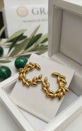 Gold leaf wreath hoop earrings displayed in gift box with circular wreath shape