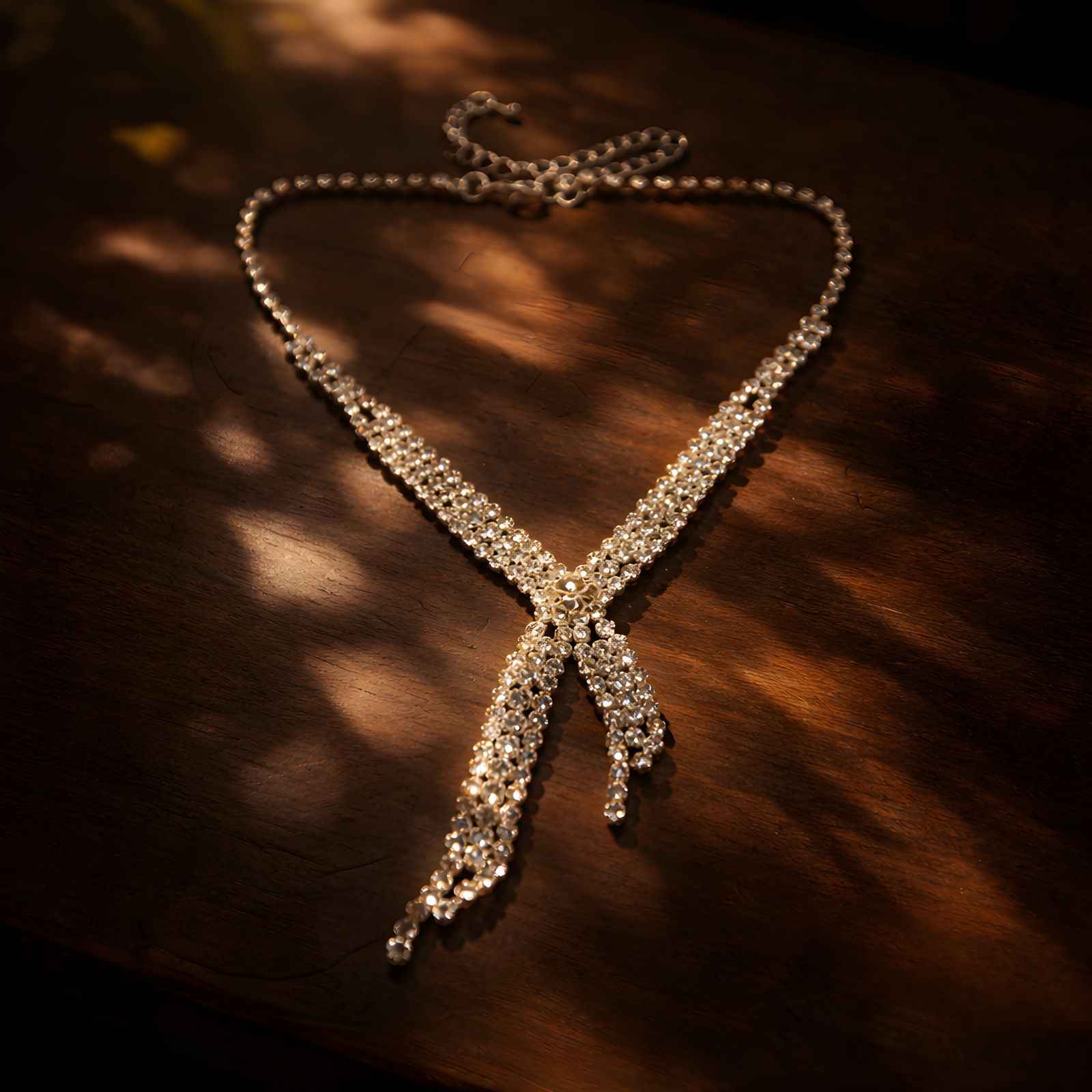 Gold-tone rhinestone X-cascade necklace with cascading pendant tassels